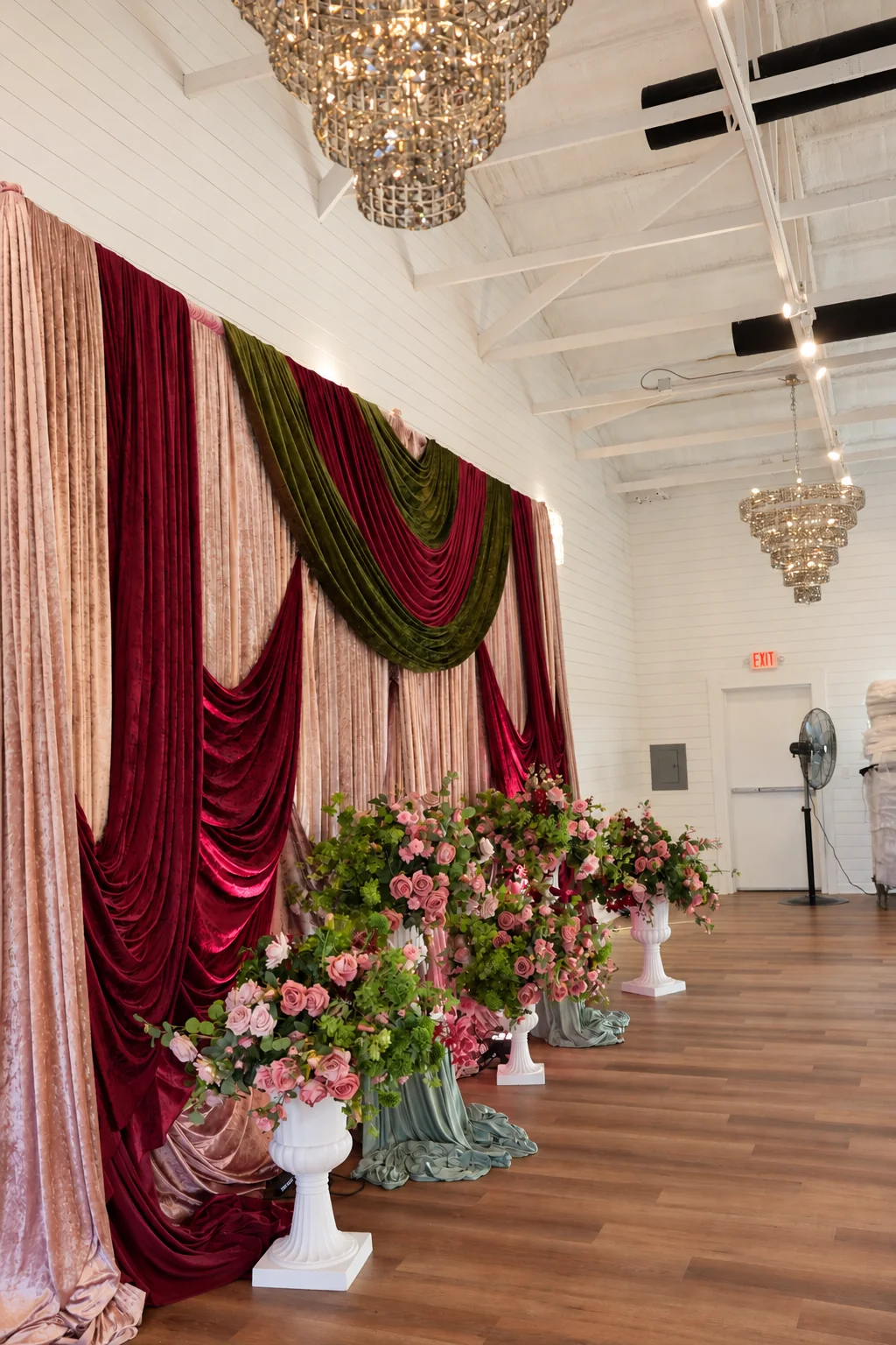 Bright event hall with chandelier and tables