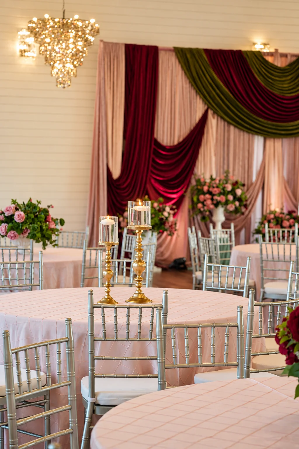 Decorated event setup beneath the ballroom chandeliers