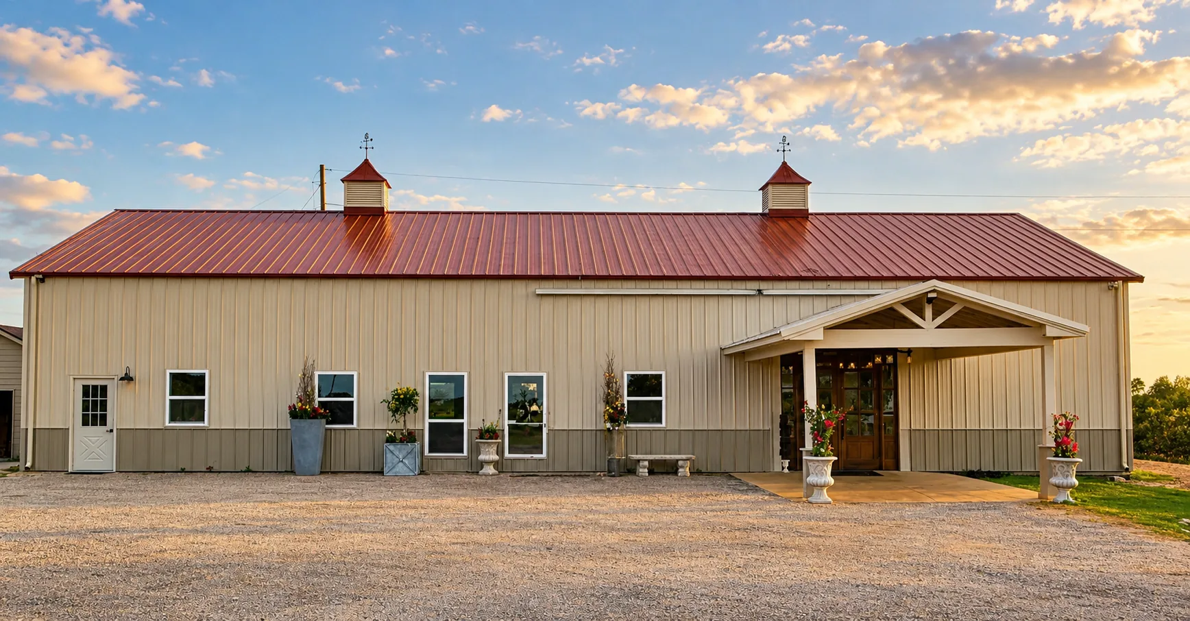 Full front elevation of the ranch hall and its covered entrance in warm light