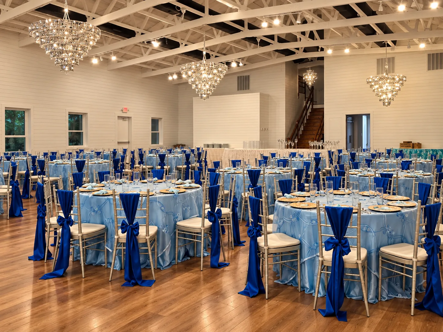 Side view across blue banquet tables inside the ranch ballroom